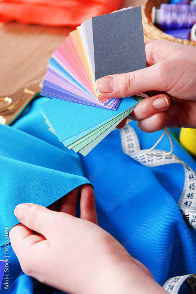 Samples of colorful fabric in female hands, closeup