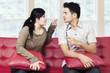 © Creativa Images - Couple quarreling while sitting on sofa