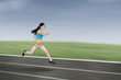 © Creativa Images - Young athletic woman running