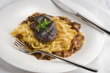 Wall Mural - Slow cooked pork cheeks in gravy with spaetzle noodles