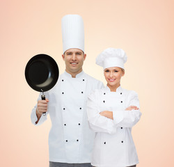 Sticker - happy chefs or cooks couple with frying pan