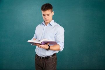 Wall Mural - English. Young teacher near chalkboard in school classroom