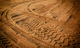 Fototapeta  - Tire tracks on the sand