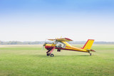 Fototapeta Konie - Small aeroplane in the field