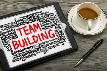 Wall Mural - team building with related word cloud hand drawing on tablet pc