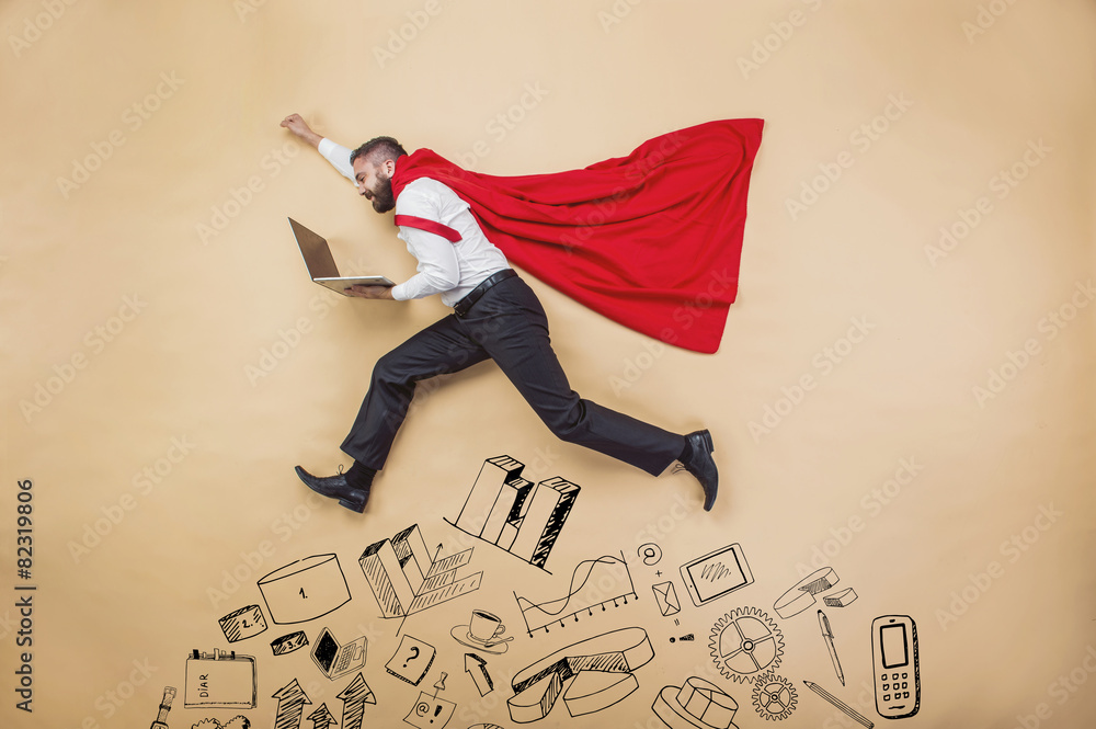 Manager in a cloak of superman. Studio shot on beige background - obrazy, fototapety, plakaty 