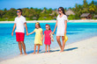 © travnikovstudio - Happy beautiful family on white beach during summer vacation