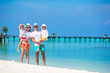 © travnikovstudio - Happy beautiful family on white beach during summer vacation
