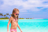 Fototapeta  - Adorable little girl at beach during summer vacation