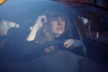 portrait of a girl in a car driver at the wheel