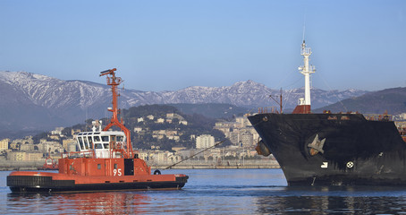 tug at working in harbor of Genoa, Italy