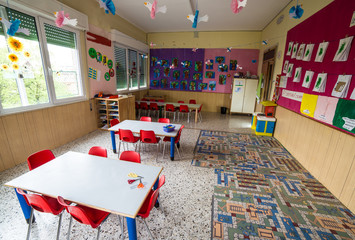 nursery class with tables and small red chairs for children