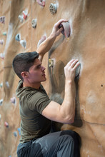 Young Man Climbing Wall Rock