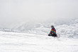 © guruXOX - Snowboarder sit at top of mountain