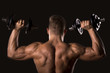 © dobok - muscle bodybuilder man from behind lifting weights