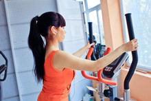 Girl Exercising At The Gym On Stepper Machine