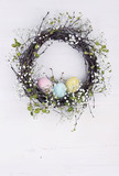 Fototapeta  - Spring wreath with Easter eggs on a wooden background