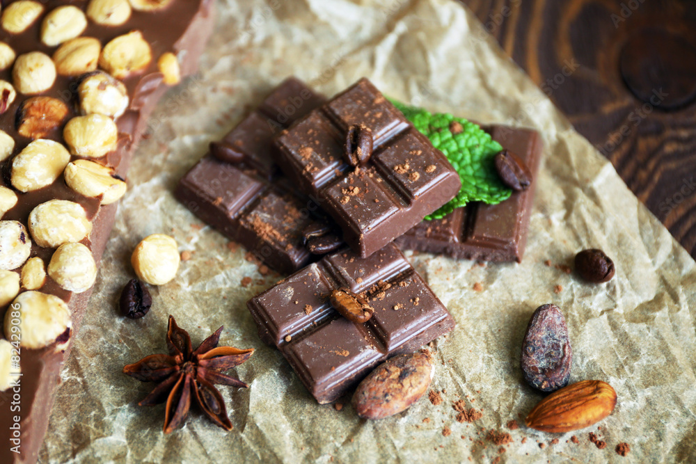 Delicious chocolates with spices on table, closeup