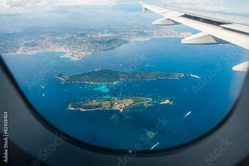 Fototapeta na wymiar Airplane wing out of window