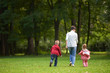 © .shock - happy family playing together outdoor in park