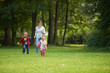 © .shock - happy family playing together outdoor in park