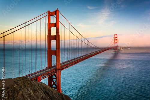 Fotografie, Obraz Sunset view of the Golden Gate Bridge and fog from Battery Spenc