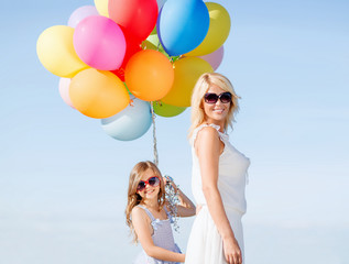 Canvas Print - mother and child with colorful balloons