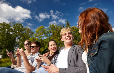 Wall Mural - students or teenagers with smartphones at campus