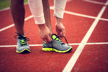 Tying shoes before run on the racetrack