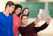 © BillionPhotos.com - Classroom. Technology concept - group of students making picture