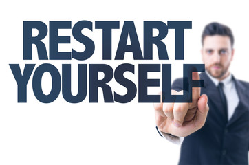 Business man pointing the text: Restart Yourself