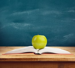 Wall Mural - Book. Green apple on a red book, isolated