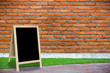 tripod blackboard in interior room with molder brick wall blackg