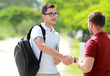 © Odua Images - college student with glasses meet his friend at college park and