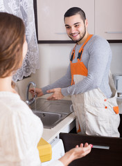 Poster - Repairman and housewife at kitchen