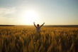 © dimedrol68 - Woman stands in a field of ripe wheat