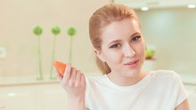 Young Woman Eating Carrot. Organic Food
