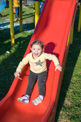 child falls from the red slide