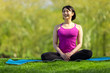 © blvdone - Young Asian woman fitness in a park yoga meditation