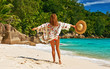 © haveseen - Woman with sarong on beach at Seychelles