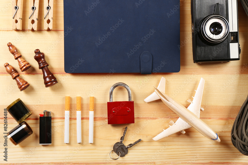 Travel gear on wooden table, top view