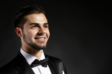 Poster - Elegant man in suit on dark background