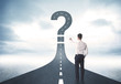 © ra2 studio - Business person lokking at road with question mark sign
