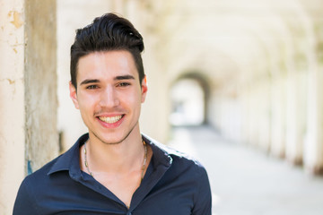 Wall Mural - Smiling young man looking at camera