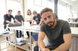 © mangostock - Owner of a small creative business and his team working