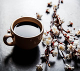 cup of coffee and pink cherry blossoms. flowers