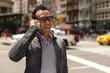 © blvdone - Young African Asian man in New York City talking on cell phone
