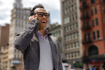 Poster - Young African Asian man in New York City talking on cell phone