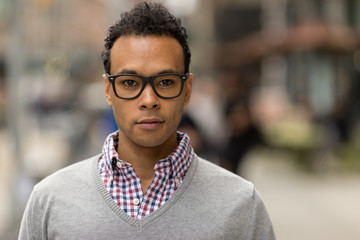 Poster - Young African Asian man in New York City serious face portrait