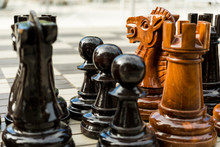 Large Street Chess Figures On The Board Including Pawns, Rook An